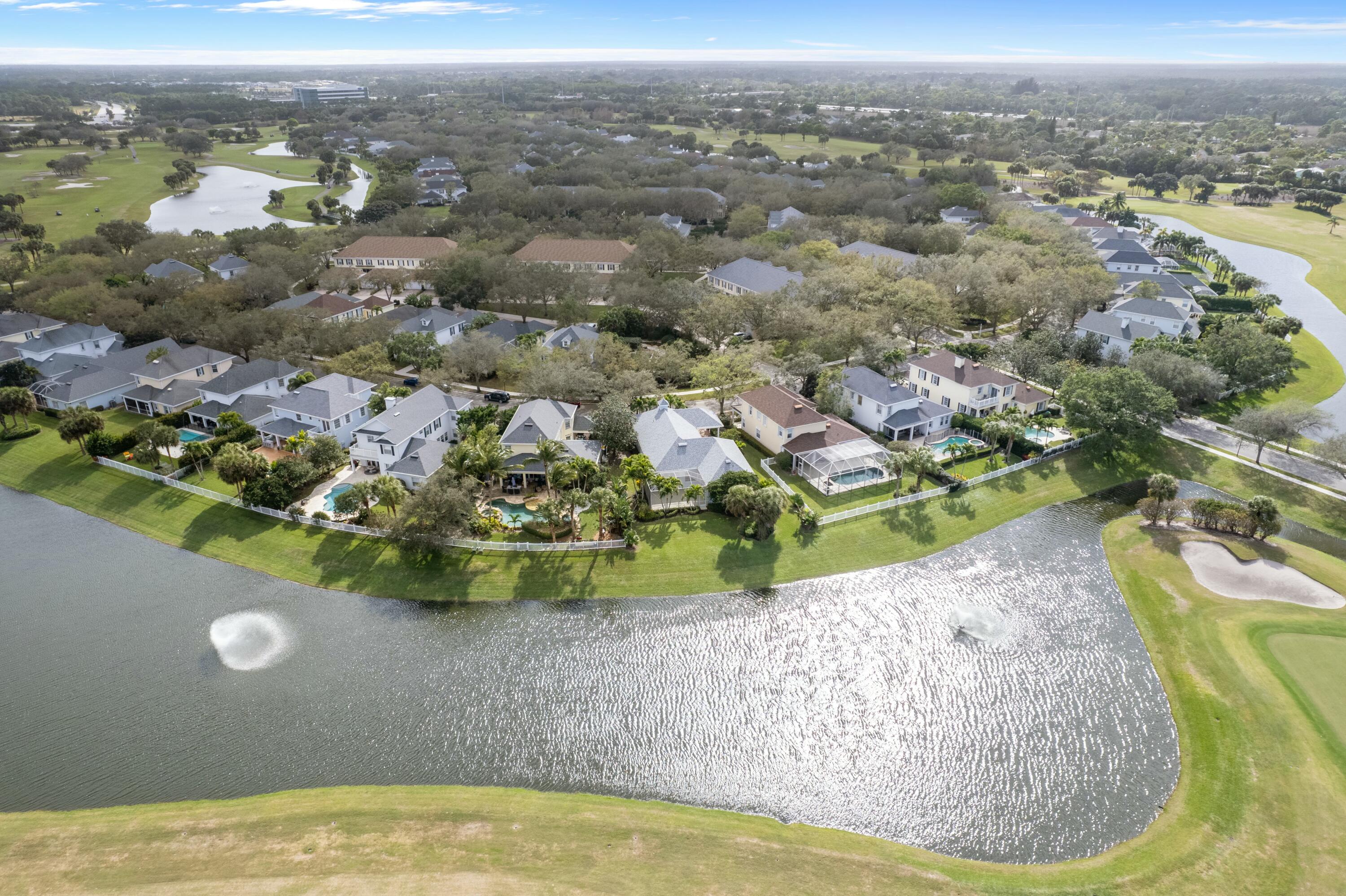 140 Barbados Drive Jupiter, FL 33458 - Photo 32 of 42 an aerial view of a house with a swimming pool yard and mountain view in back