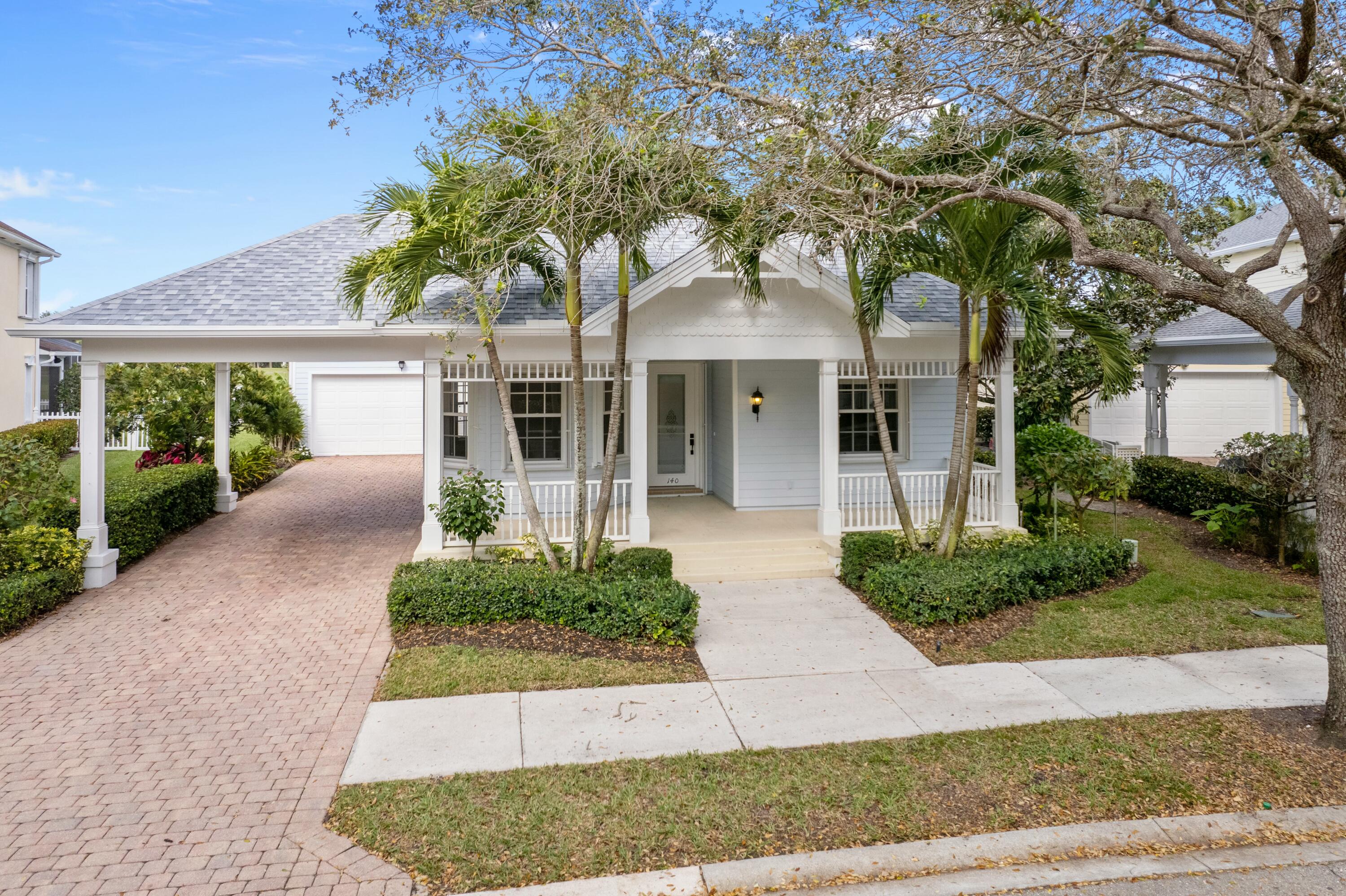 140 Barbados Drive Jupiter, FL 33458 - Photo 38 of 42 front view of a house with a garden