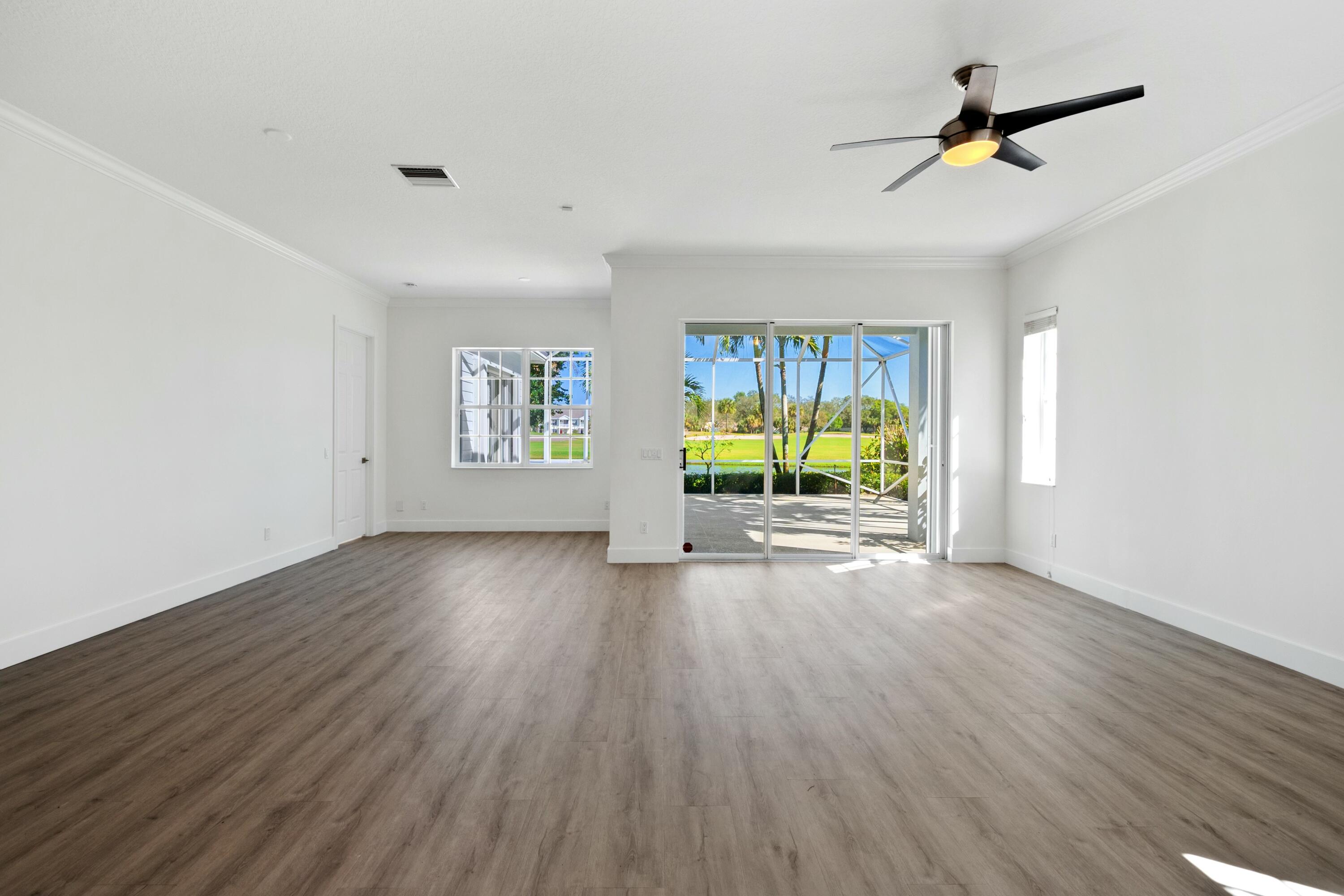 140 Barbados Drive Jupiter, FL 33458 - Photo 41 of 42 a view of an empty room with a window and wooden floor