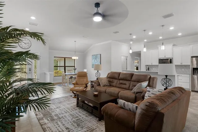 a living room with furniture fireplace and potted plant
