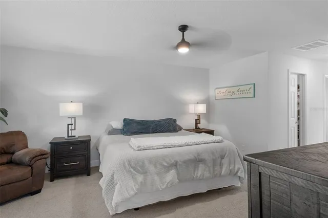 a bedroom with a bed and ceiling fan