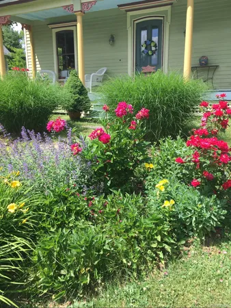 a view of a house with a flower garden
