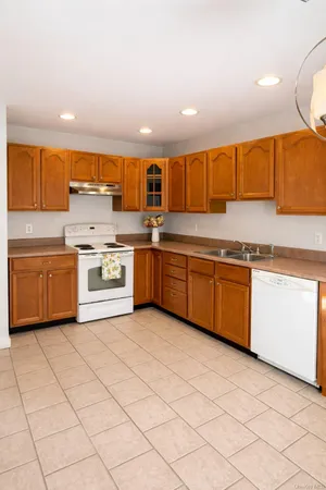 a kitchen with stainless steel appliances granite countertop a stove and a sink