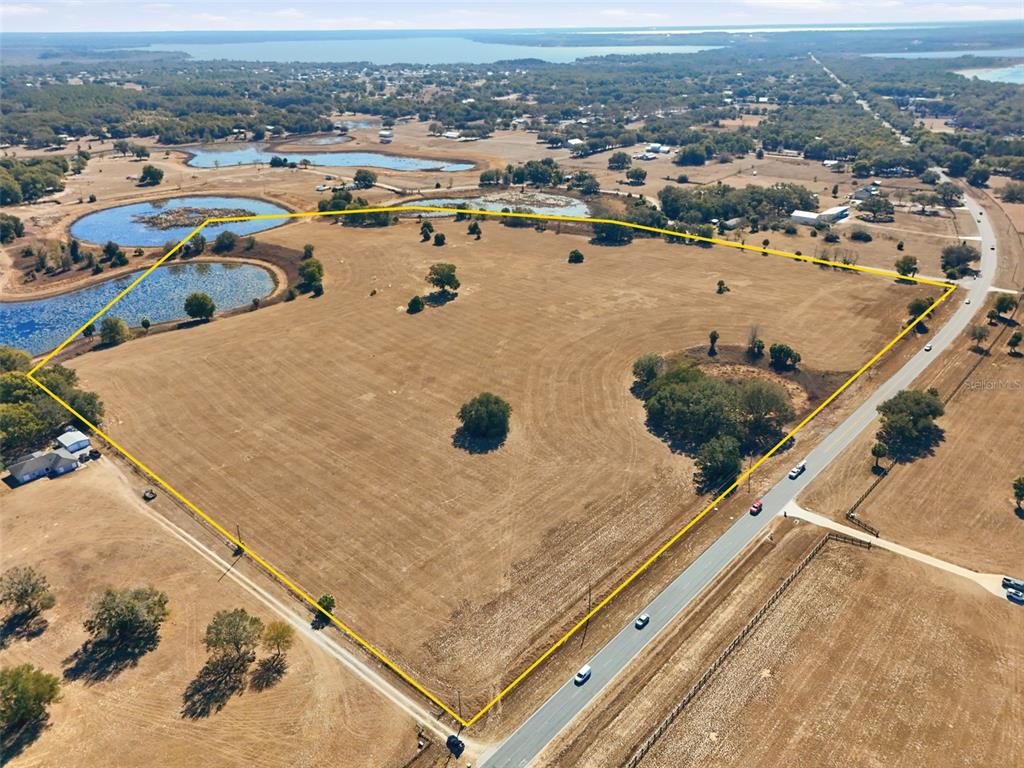Emerald Avenue Leesburg, FL 34788 - Photo 2 of 8 an aerial view of residential houses with outdoor space