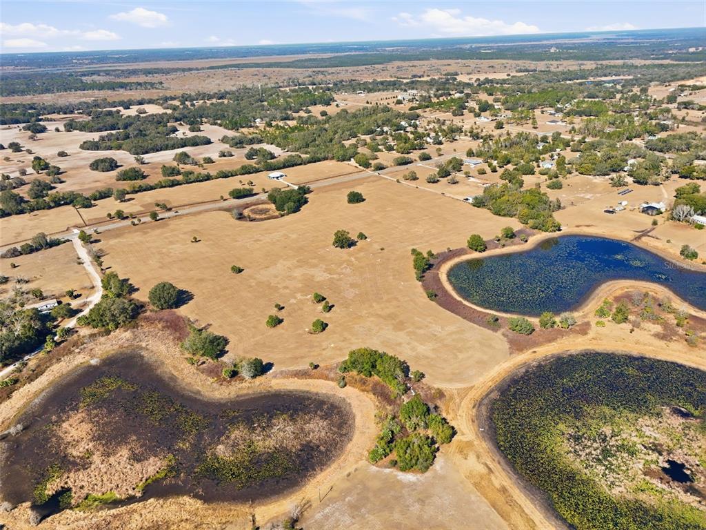 Emerald Avenue Leesburg, FL 34788 - Photo 5 of 8 an aerial view of residential houses with outdoor space