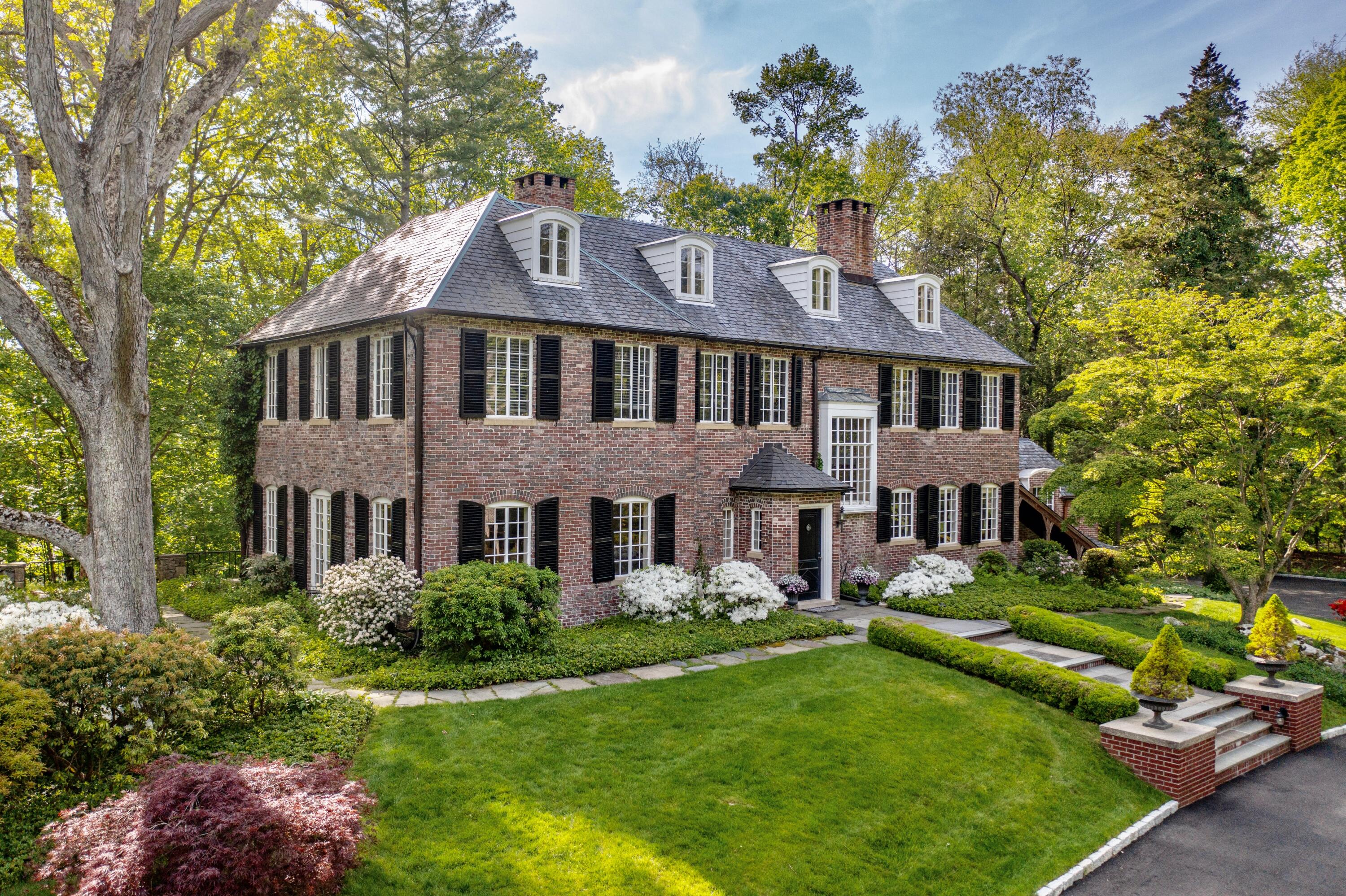 360 Greenley Road New Canaan, CT 06840 - Photo 2 of 22 a front view of a house with a yard