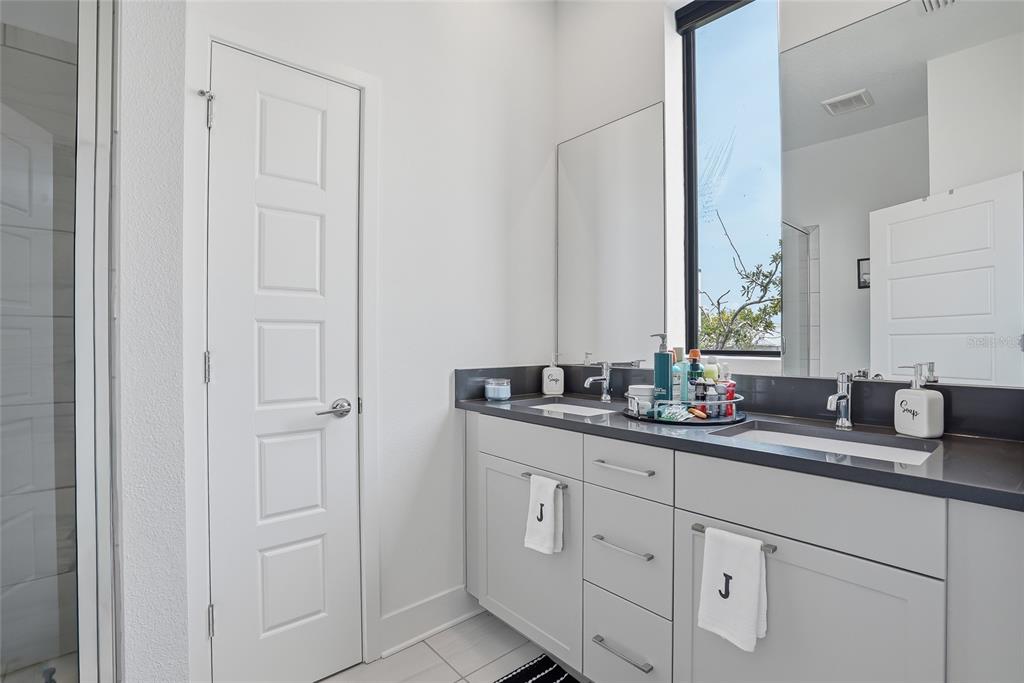 4810 West McElroy Avenue, Unit 30 Tampa, FL 33611 - Photo 26 of 43 a bathroom with double sink and a mirror