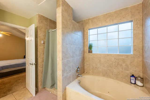 a bathroom with a tub and shower