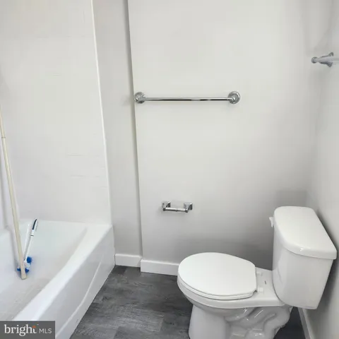 a bathroom with a toilet and a bathtub