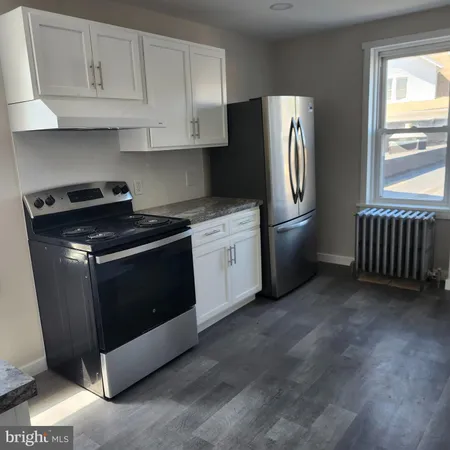 a kitchen with stainless steel appliances granite countertop a refrigerator a stove a sink and a microwave