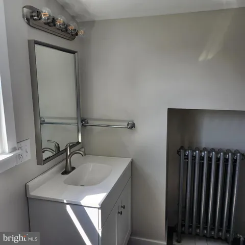 a bathroom with a sink a vanity and a mirror
