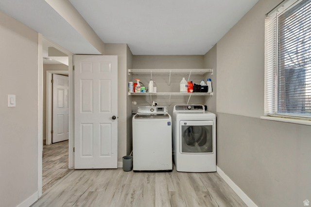 933 South Freedom Boulevard, Unit 7 Provo, UT 84601 - Photo 17 of 23 Laundry area with light wood-style floors and washer and dryer