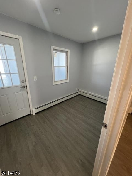 21 Alva Street, Unit 2 Bloomfield, NJ 07003 - Photo 15 of 16 an empty room with wooden floor and windows