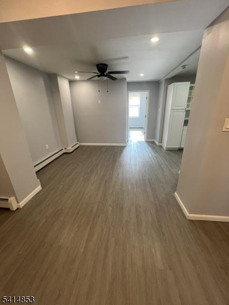 21 Alva Street, Unit 2 Bloomfield, NJ 07003 - Photo 4 of 16 an empty room with wooden floor and windows