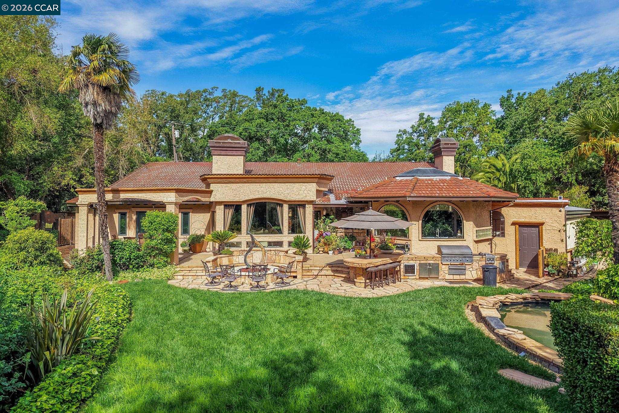 490 St Marys Road Lafayette, CA 94549 - Photo 45 of 61 a view of a patio with table and chairs under an umbrella
