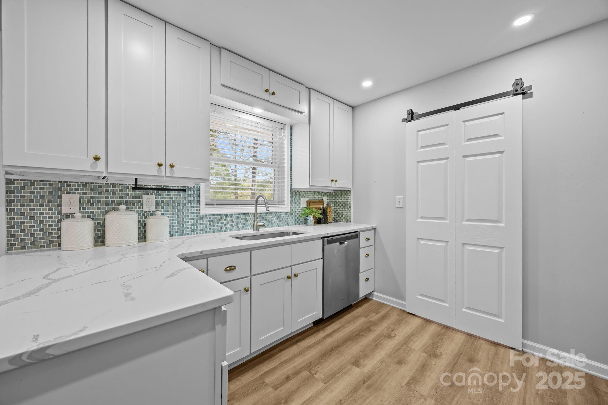 1813 Doster Road Monroe, NC 28112 - Photo 11 of 47 a kitchen with a sink cabinets and window