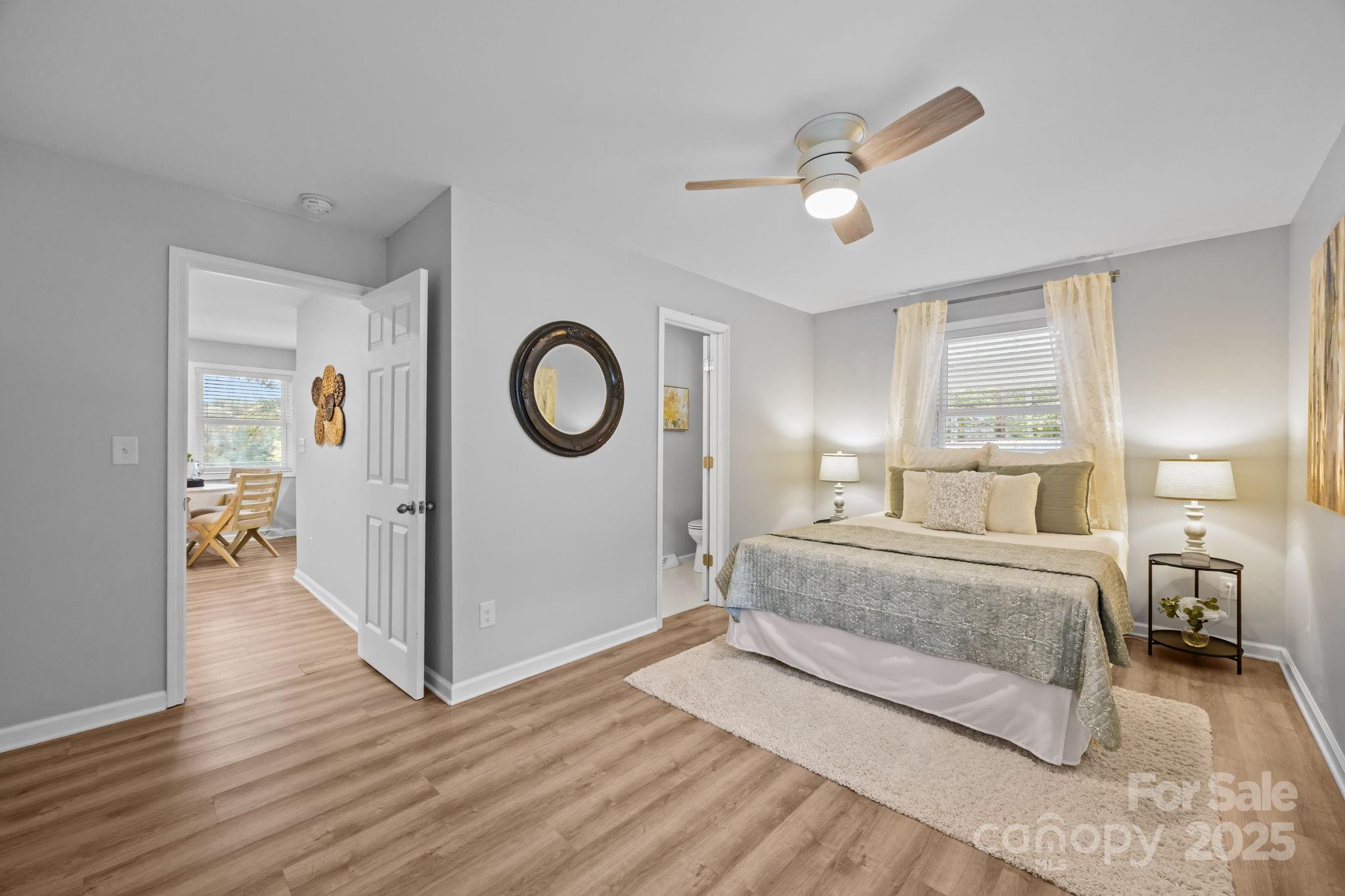 1813 Doster Road Monroe, NC 28112 - Photo 13 of 47 a spacious bedroom with a large bed and a chandelier