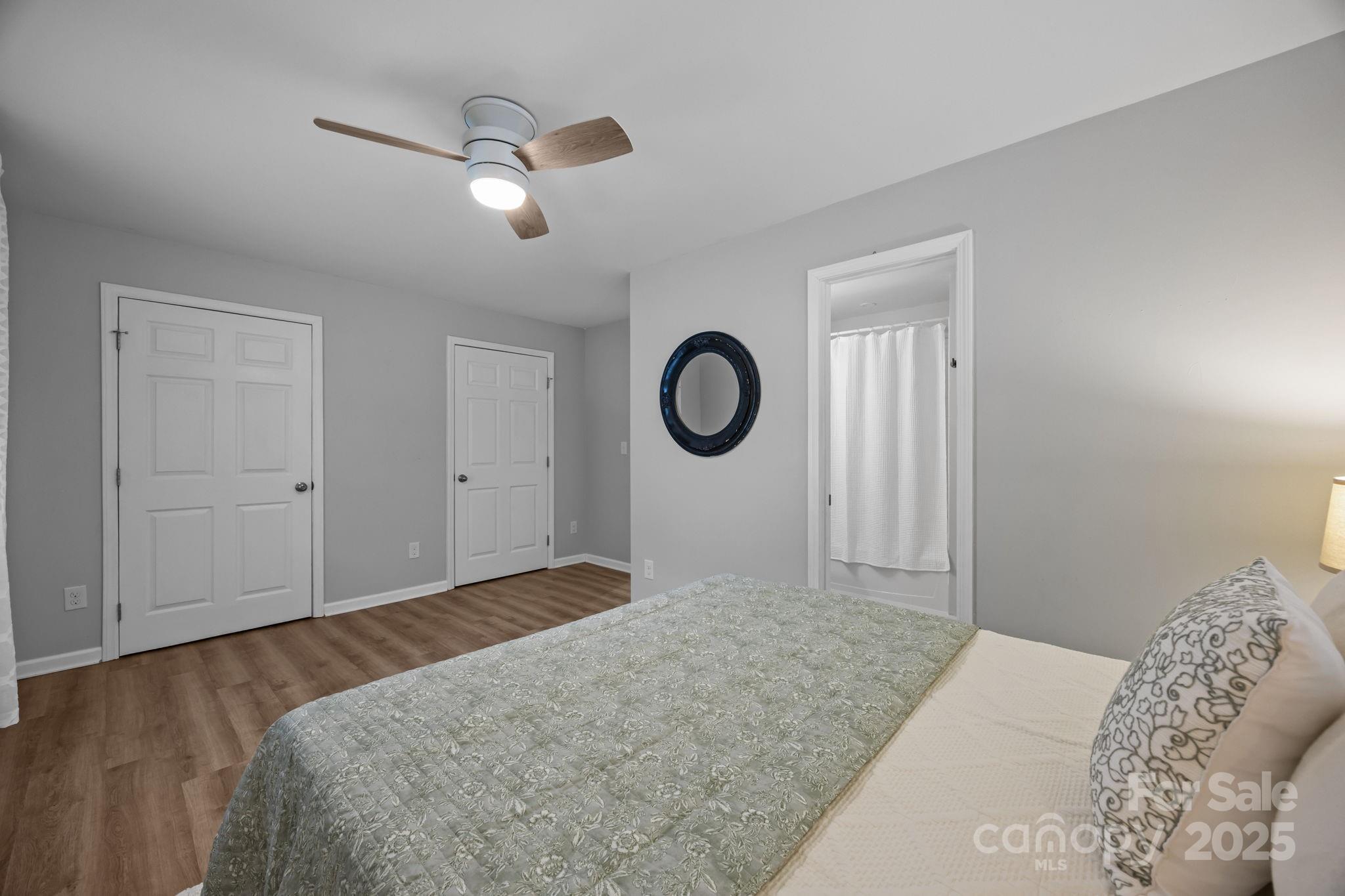 1813 Doster Road Monroe, NC 28112 - Photo 14 of 47 a bedroom with a bed and a chandelier