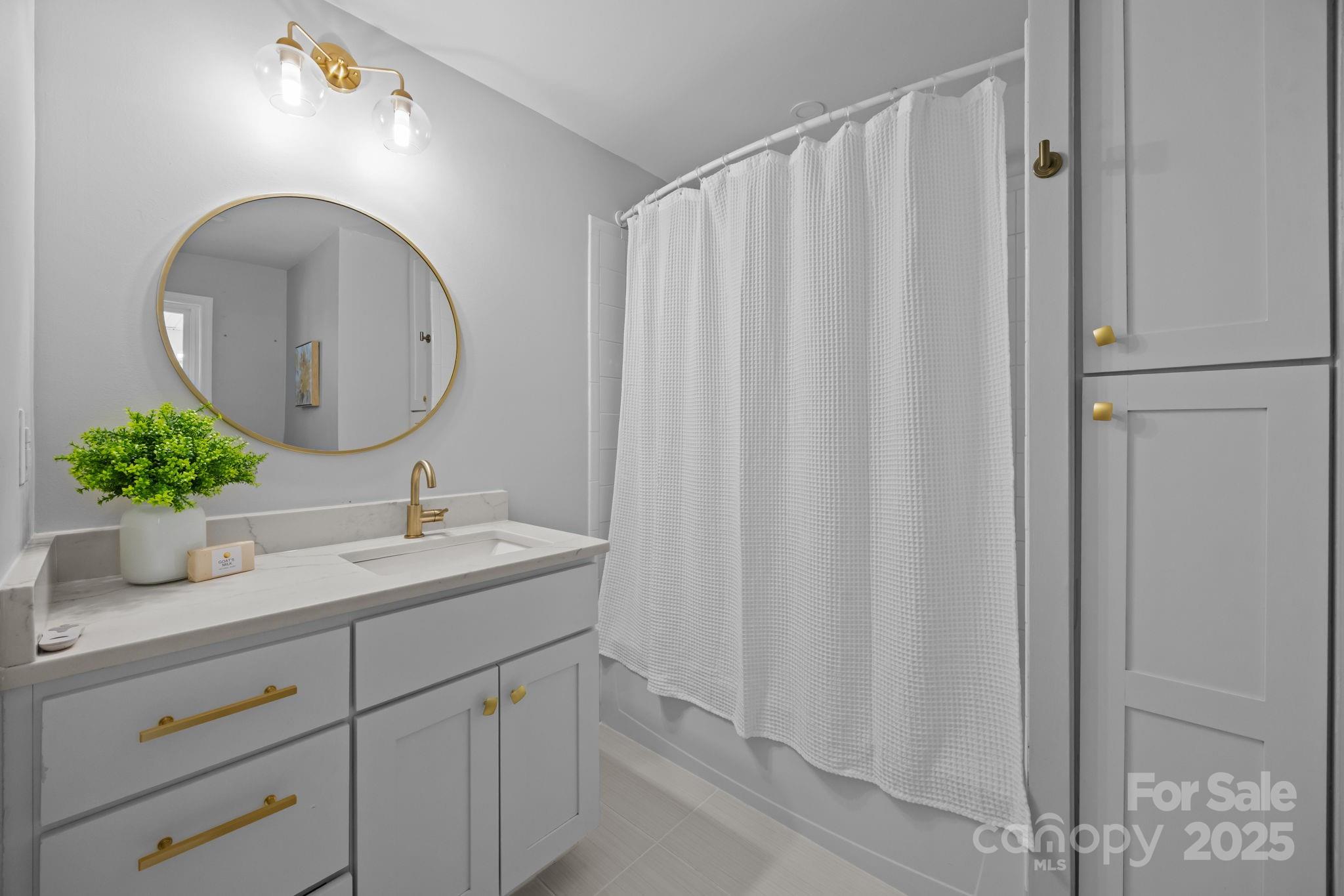 1813 Doster Road Monroe, NC 28112 - Photo 15 of 47 a bathroom with a double vanity sink and mirror