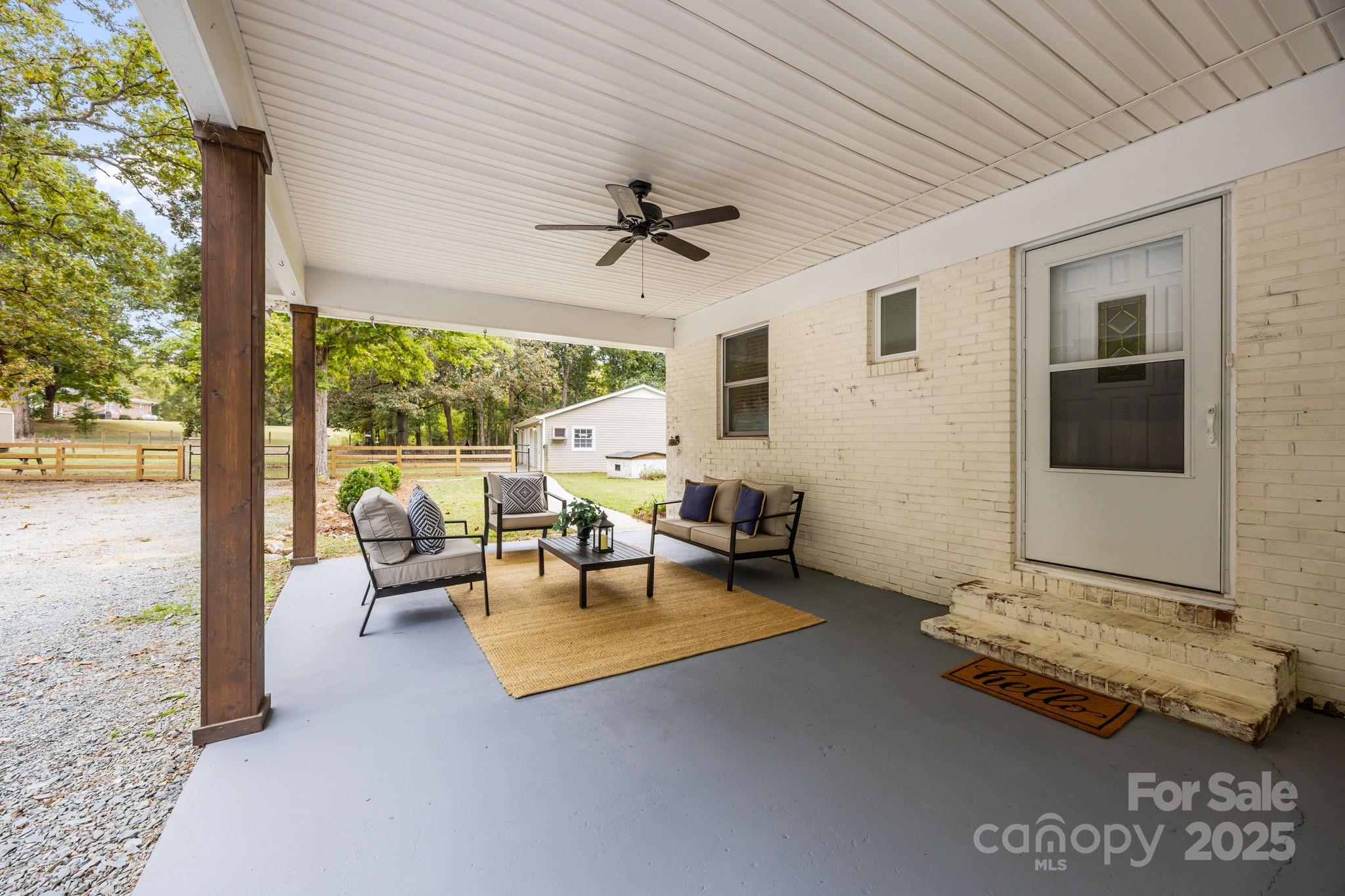 1813 Doster Road Monroe, NC 28112 - Photo 21 of 47 a living room with patio furniture and a floor to ceiling window
