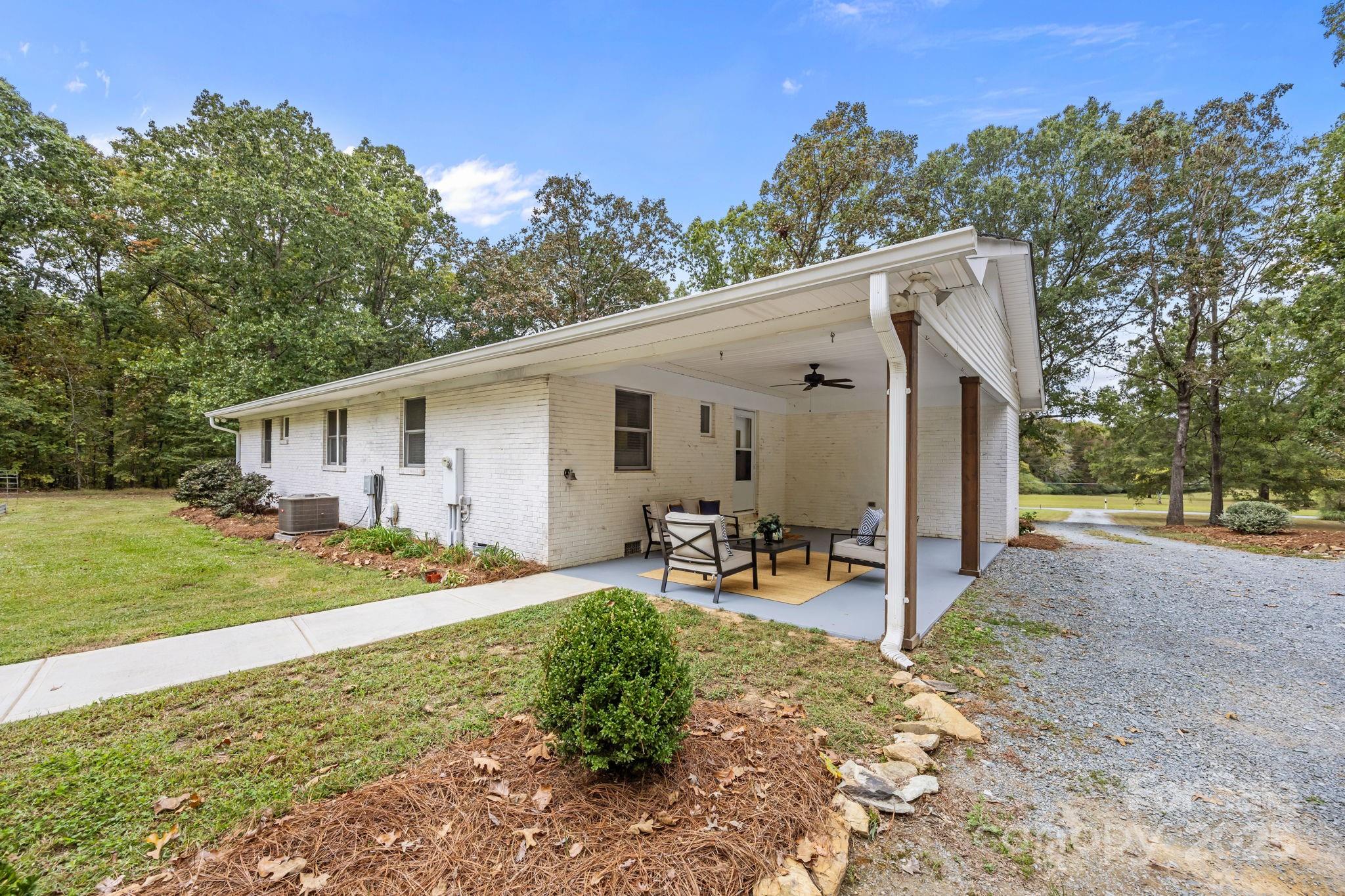 1813 Doster Road Monroe, NC 28112 - Photo 23 of 47 a view of a house with backyard and a tree