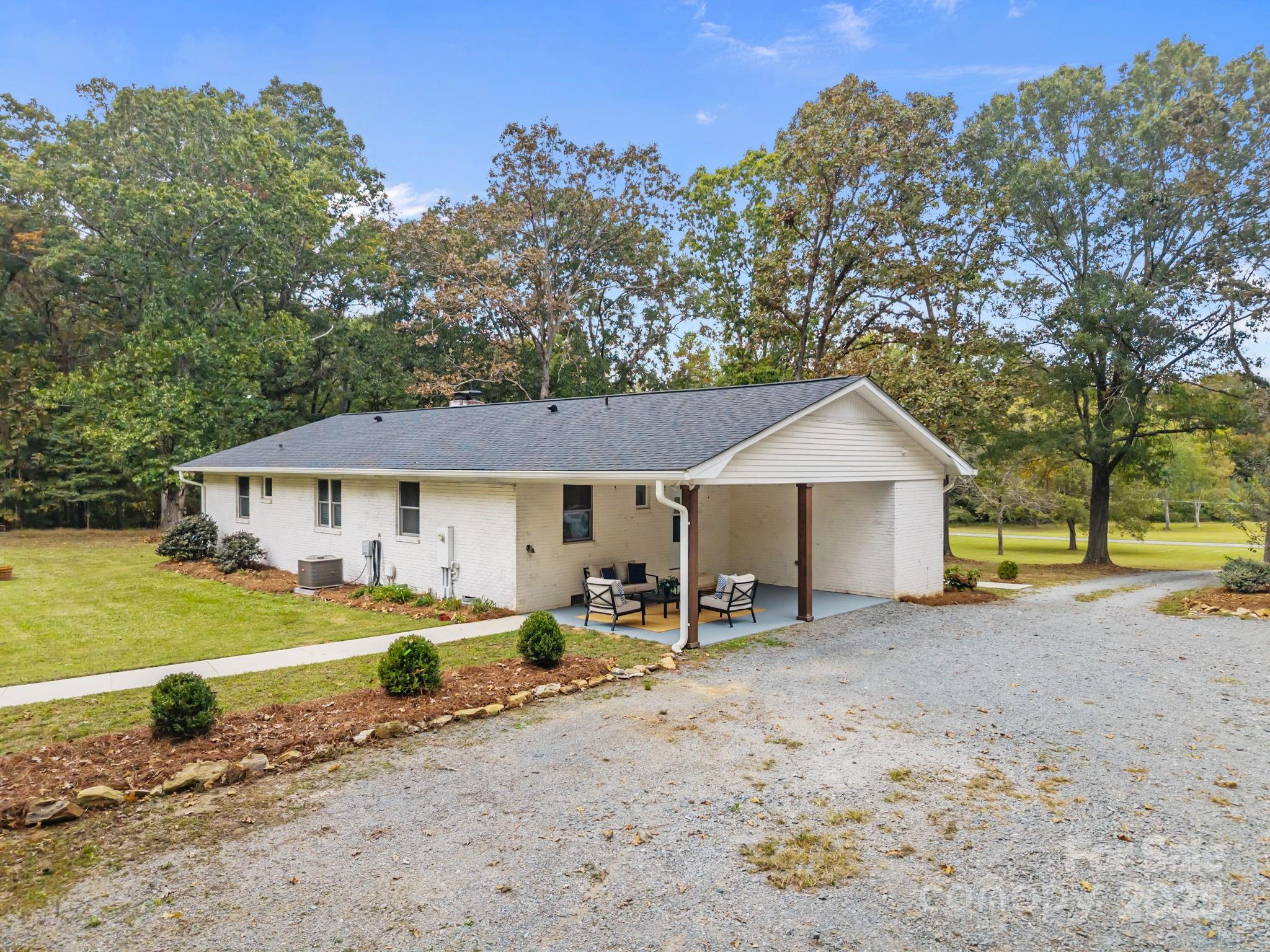 1813 Doster Road Monroe, NC 28112 - Photo 24 of 47 a view of a house with backyard and trees