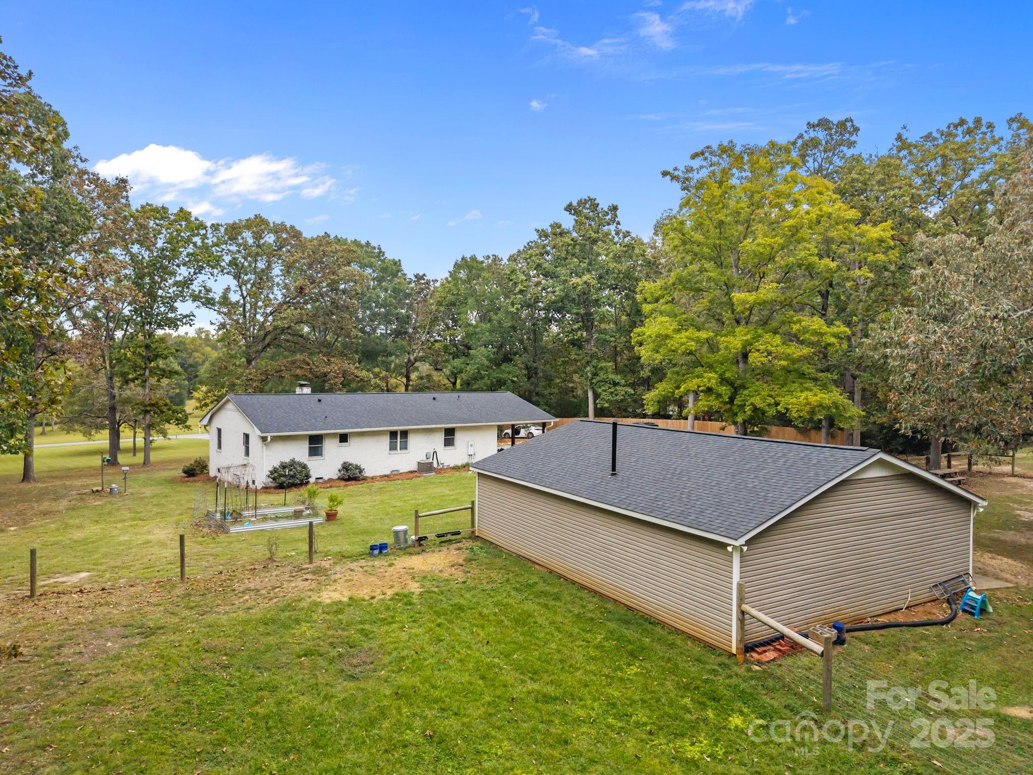 1813 Doster Road Monroe, NC 28112 - Photo 31 of 47 a aerial view of a house with swimming pool and large trees