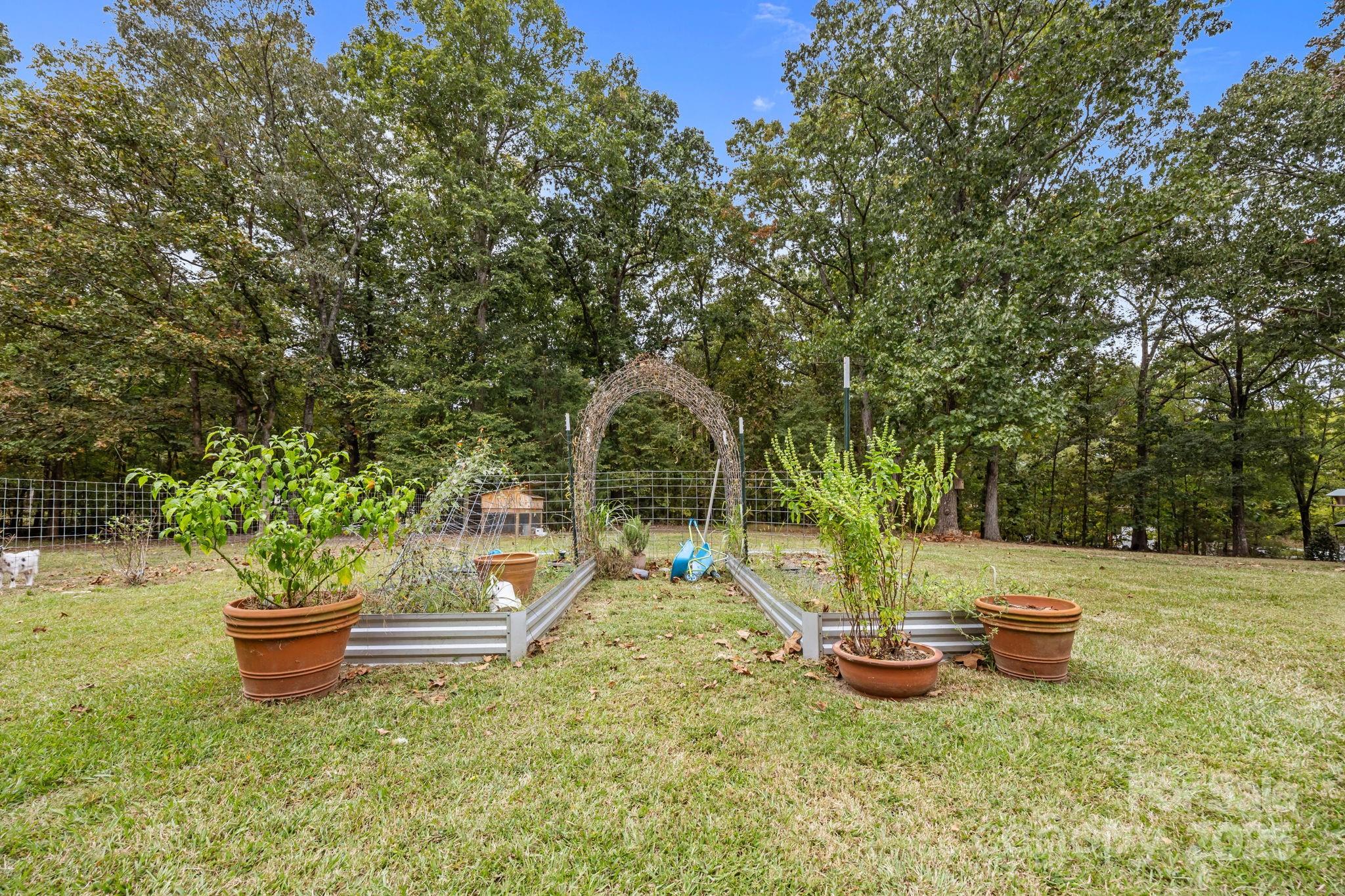 1813 Doster Road Monroe, NC 28112 - Photo 34 of 47 a backyard of a house with fountain table and chairs