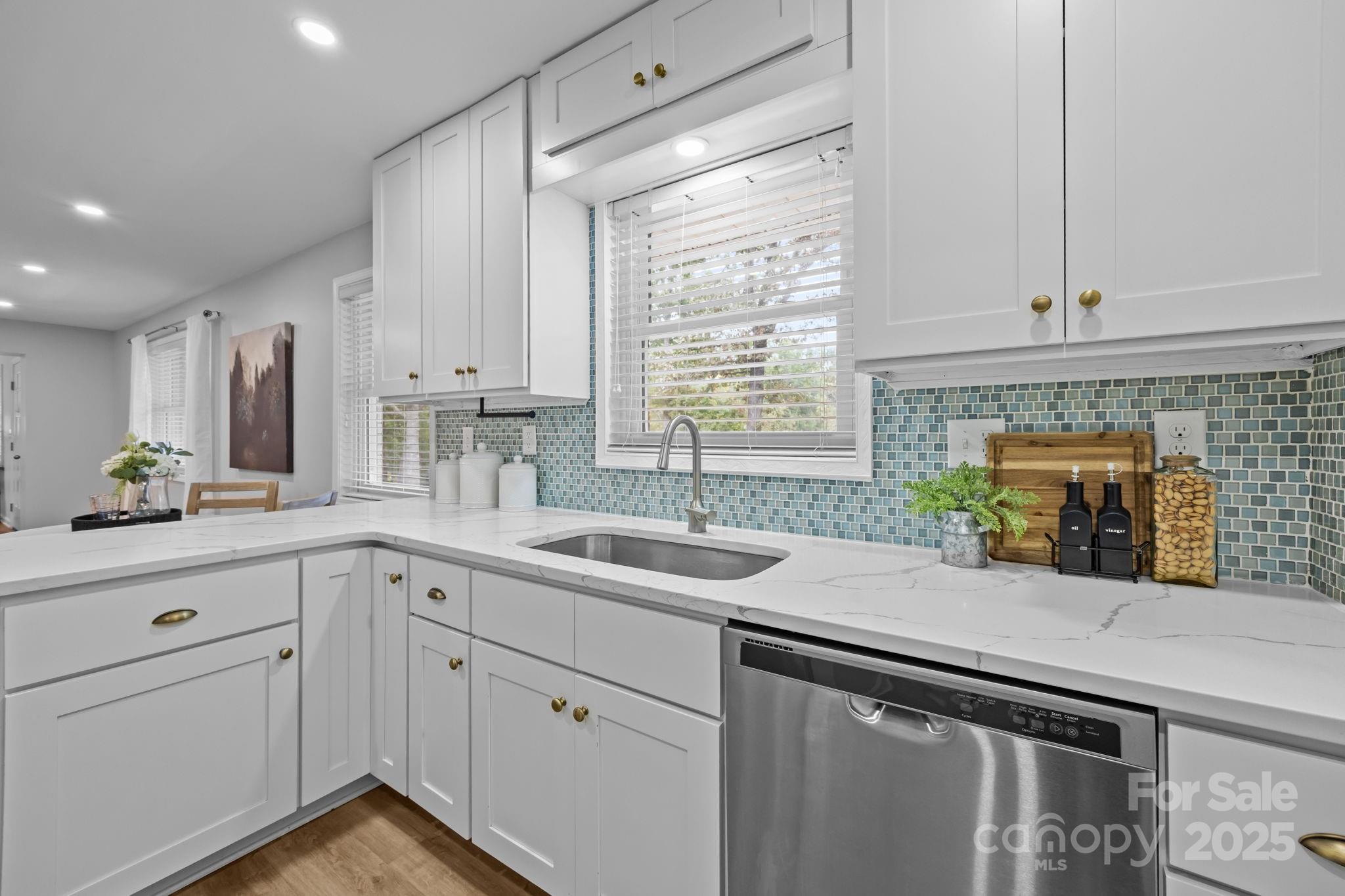 1813 Doster Road Monroe, NC 28112 - Photo 9 of 47 a kitchen with a sink stove and cabinets