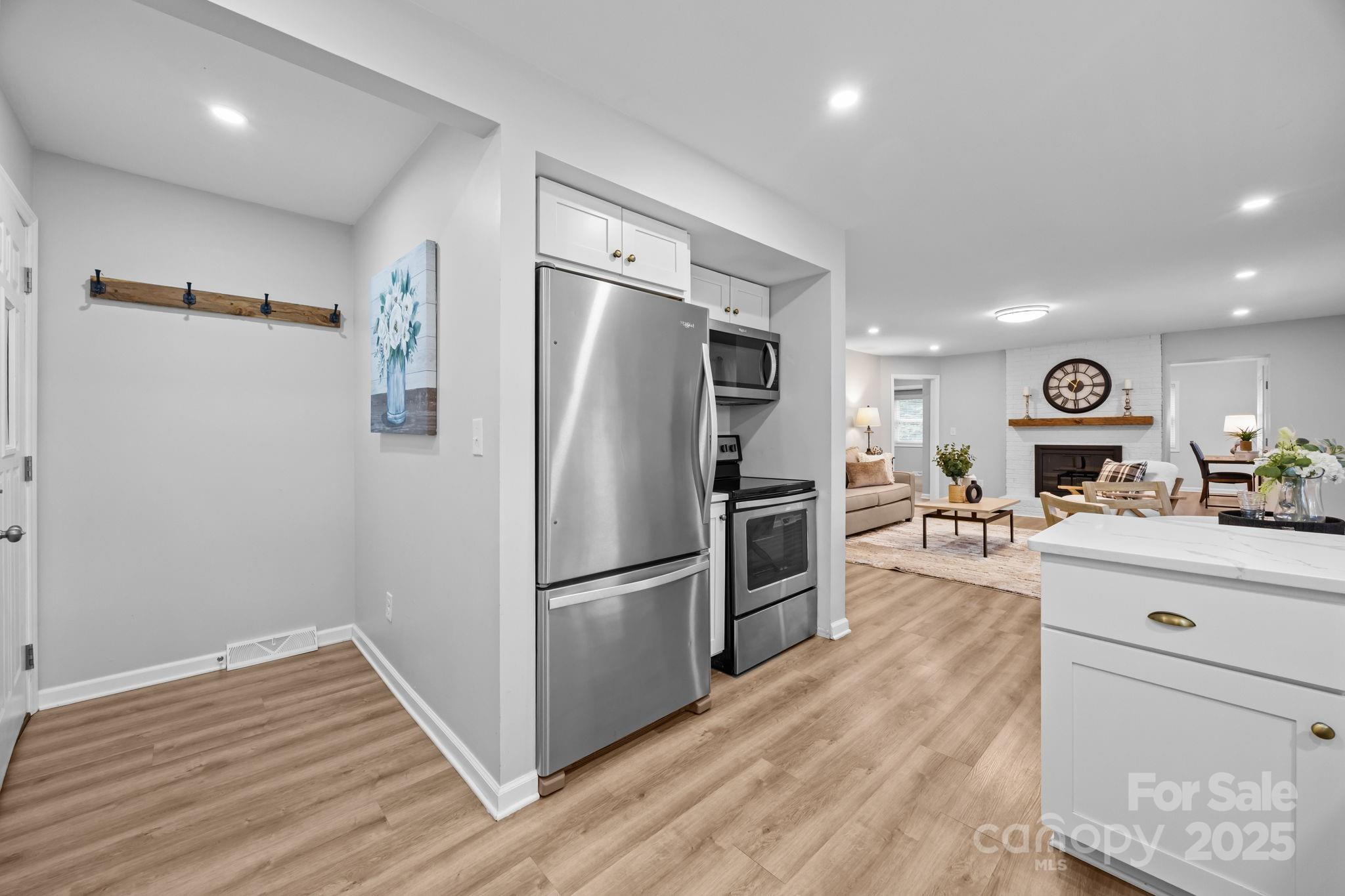 1813 Doster Road Monroe, NC 28112 - Photo 10 of 47 a kitchen with granite countertop a refrigerator and a stove top oven