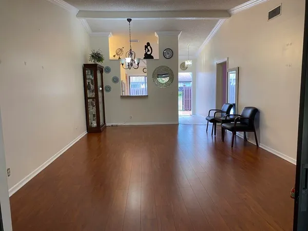 a view of a livingroom with furniture hardwood floor and a chandelier