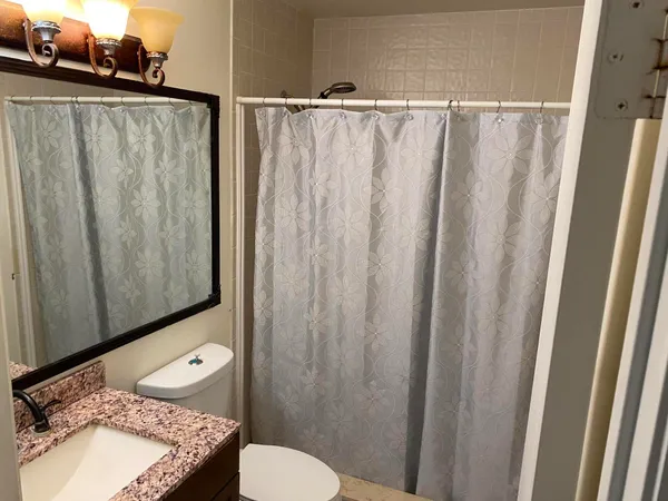 a bathroom with a sink toilet and mirror