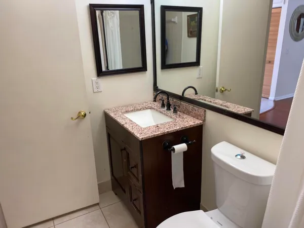 a white toilet sitting next to a bathroom sink