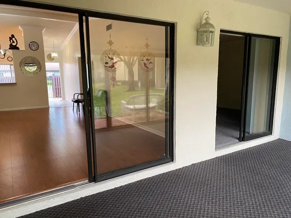 a view of empty room with wooden floor and city view
