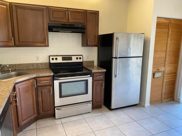 a kitchen with cabinets and steel stainless steel appliances