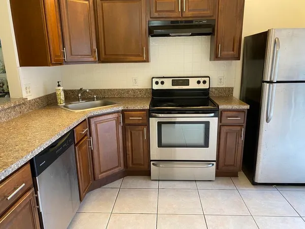a kitchen with a stove top oven and cabinets