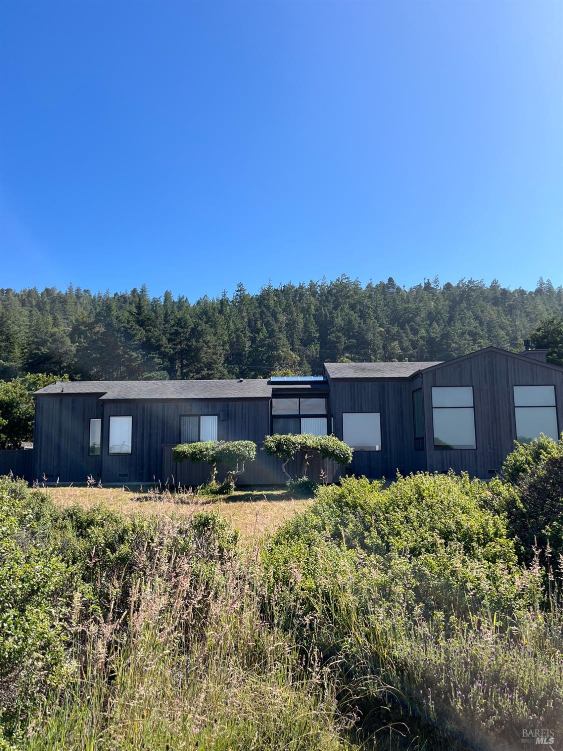 39722 Leeward Road, Unit 28 The Sea Ranch, CA 95497 - Photo 24 of 36 a view of a house with a yard and sitting area