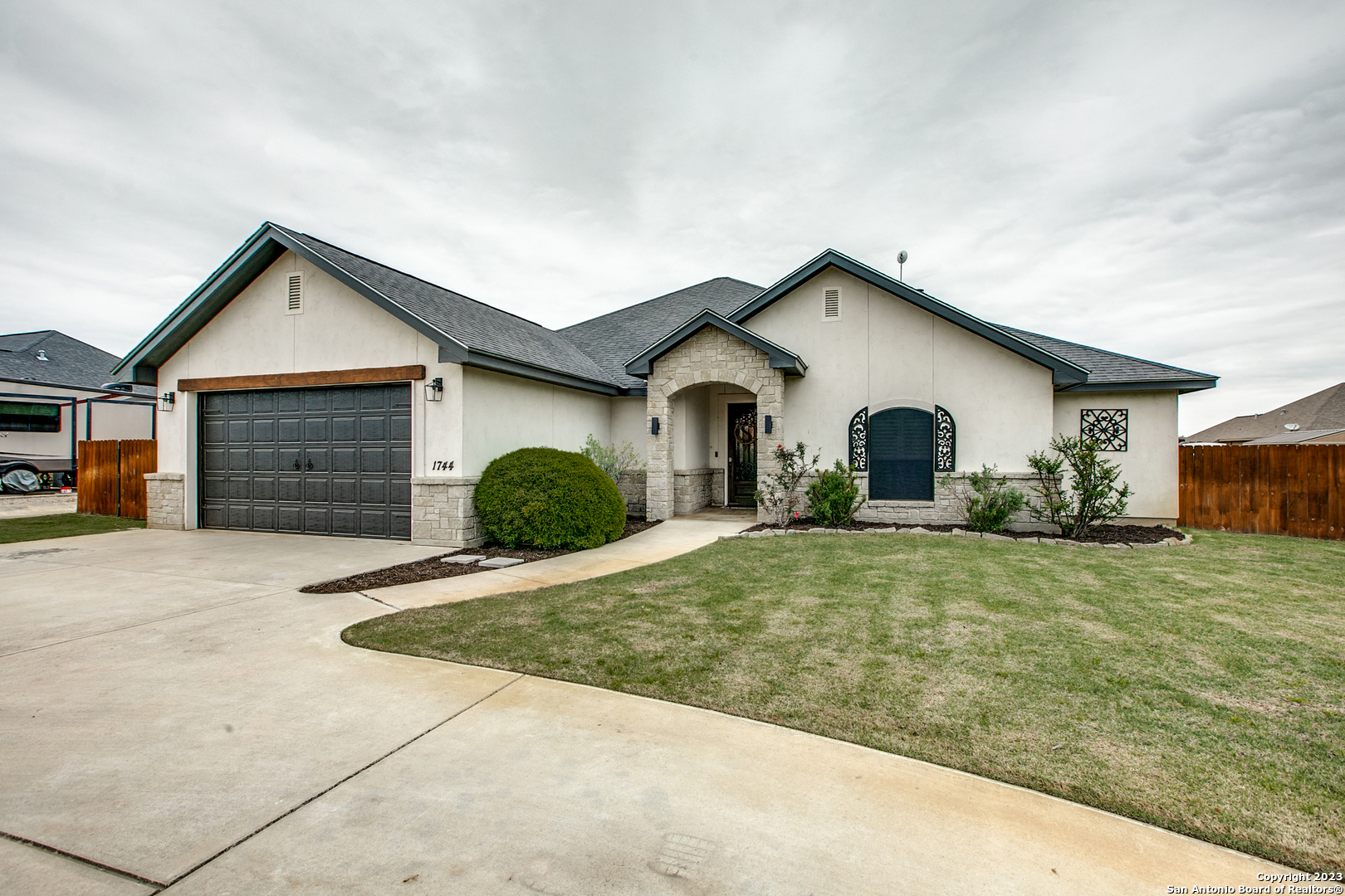 1744 Stone Haven Pleasanton, TX 78064 - Photo 1 of 1 a front view of a house with a yard and garage