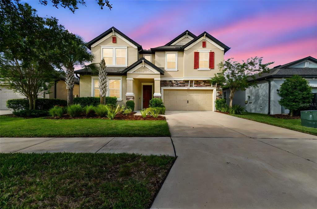 6501 Dutton Drive Wesley Chapel, FL 33545 - Photo 1 of 1 a front view of a house with a yard and garage