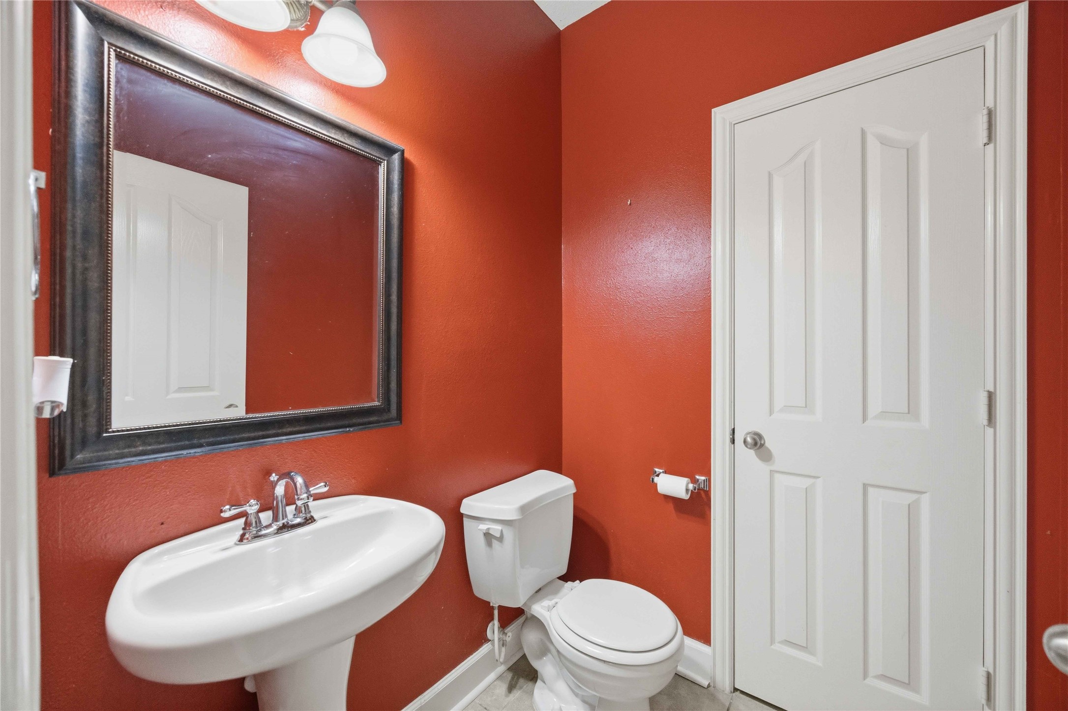 803 Northridge Terrace Lane Spring, TX 77373 - Photo 20 of 42 a bathroom with a toilet a sink and a mirror