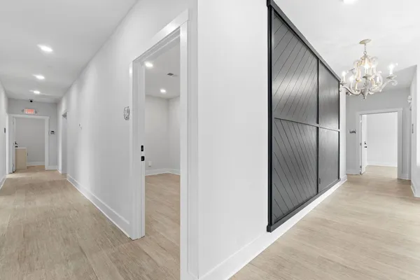 a view of a hallway with wooden floor