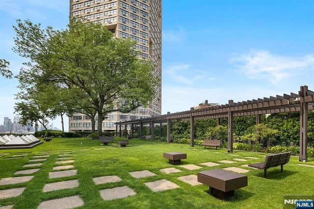 a view of a white house with a yard table and chairs