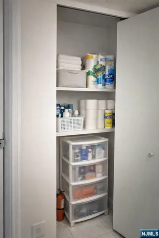 a shelf with cup and plates