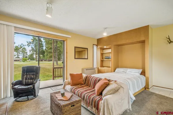 a bedroom with a bed and glass window