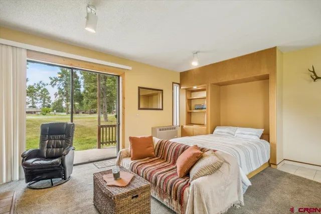 a bedroom with a bed and glass window