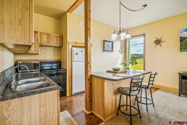 a kitchen with stainless steel appliances granite countertop a stove and a refrigerator
