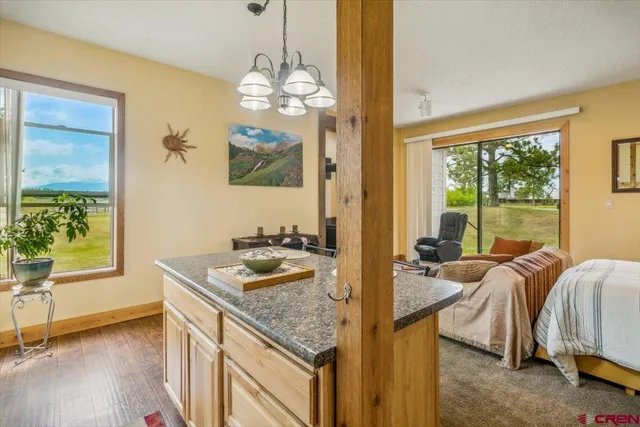a living room with a bed furniture and a chandelier