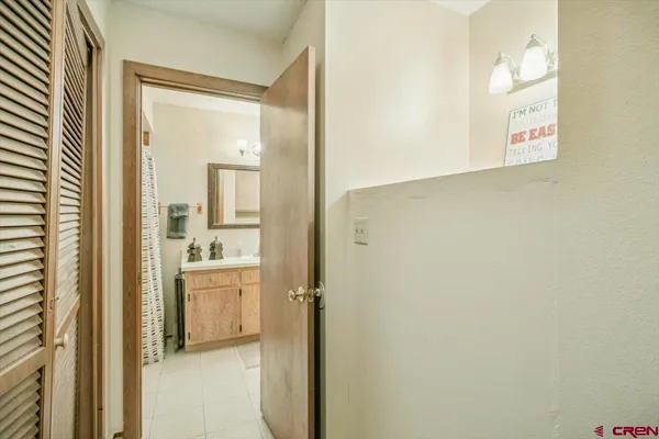 a en suite bathroom with a granite countertop sink and a mirror