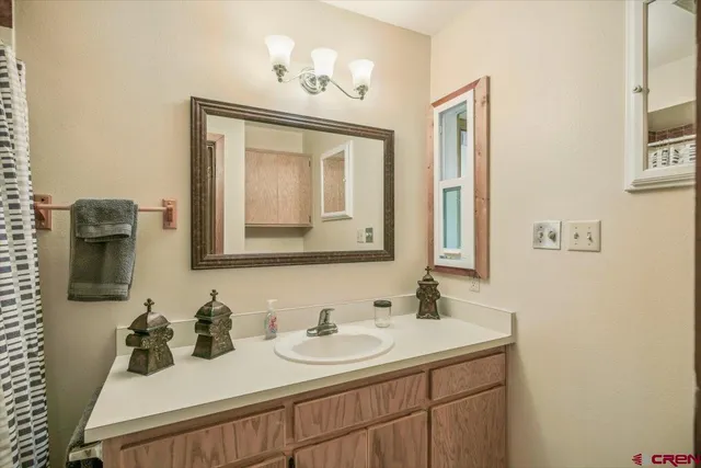 a bathroom with 2 sink and a mirror