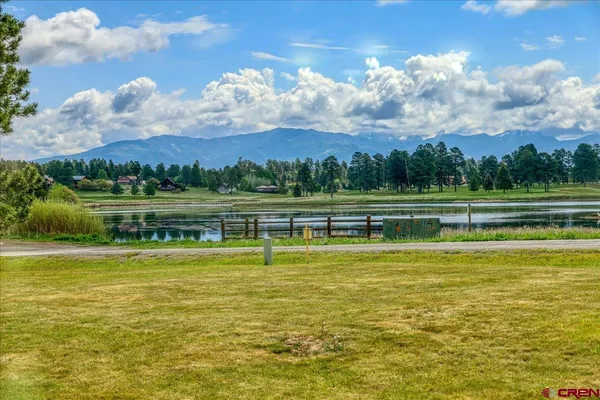 a view of a lake with houses in the background